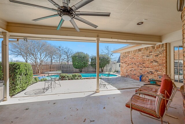 view of patio with a fenced in pool, a fenced backyard, and ceiling fan