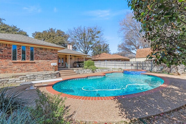 view of swimming pool with fence, a fenced in pool, a diving board, french doors, and a patio area