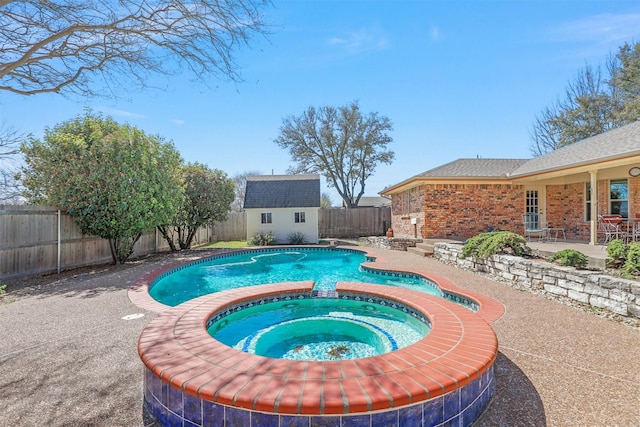 view of pool with a fenced in pool, an in ground hot tub, a fenced backyard, a storage shed, and a patio area