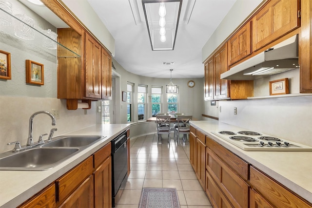 kitchen with white electric stovetop, a sink, under cabinet range hood, dishwasher, and brown cabinets