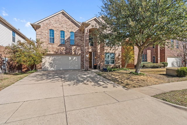 traditional home featuring a garage, concrete driveway, and brick siding