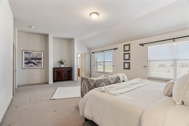 bedroom featuring lofted ceiling, baseboards, and light colored carpet