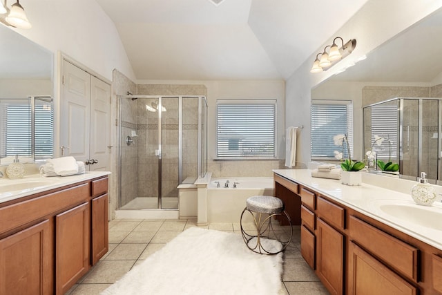 bathroom with vaulted ceiling, a sink, and tile patterned floors