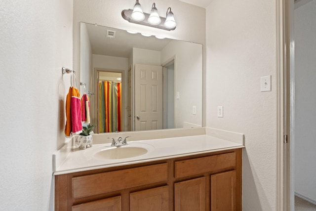 bathroom with visible vents and vanity