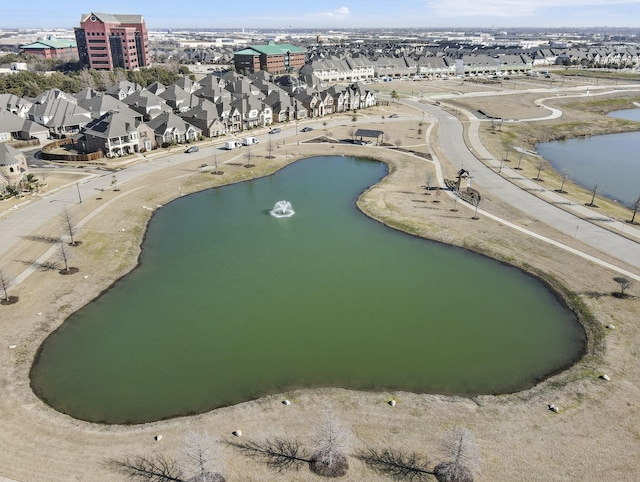 drone / aerial view with a water view and a residential view