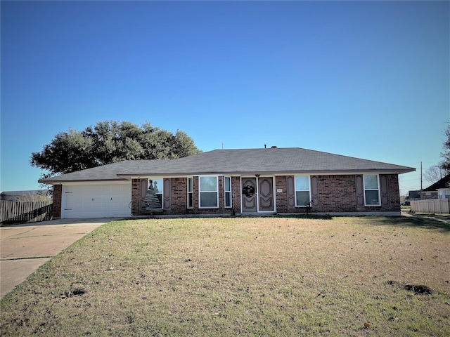 single story home featuring driveway, a garage, brick siding, fence, and a front yard