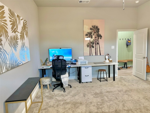 office area with light carpet, visible vents, and baseboards