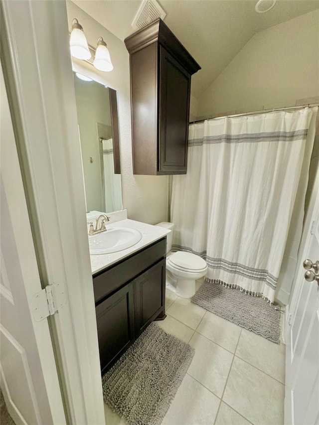 bathroom featuring visible vents, toilet, tile patterned flooring, vaulted ceiling, and vanity