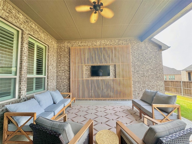 view of patio featuring fence, an outdoor living space, and a ceiling fan