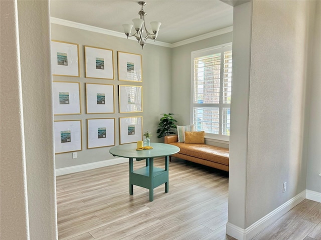 living area featuring baseboards, ornamental molding, light wood-type flooring, and an inviting chandelier