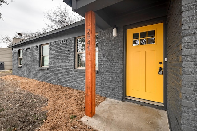 entrance to property with brick siding