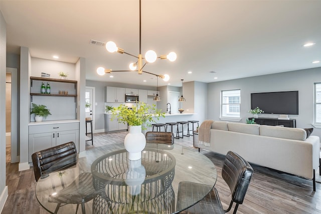 dining room with light wood-style flooring, visible vents, and recessed lighting