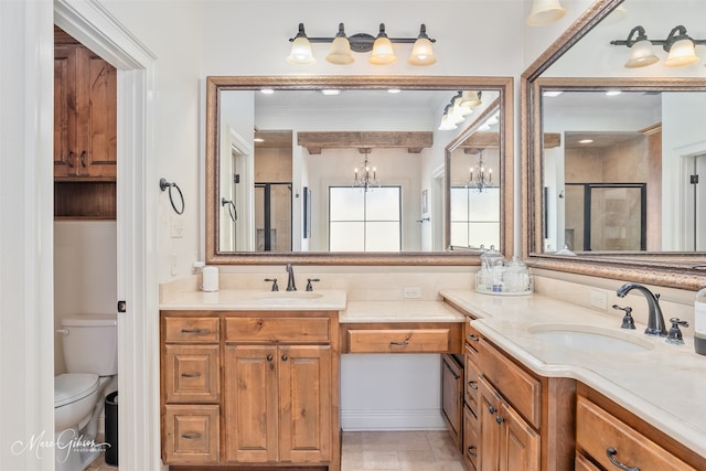 bathroom featuring a sink, toilet, and a shower stall