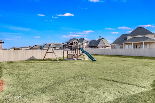 view of play area featuring a yard, a residential view, and a fenced backyard