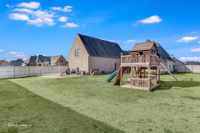 view of jungle gym with a patio area, a lawn, and a fenced backyard