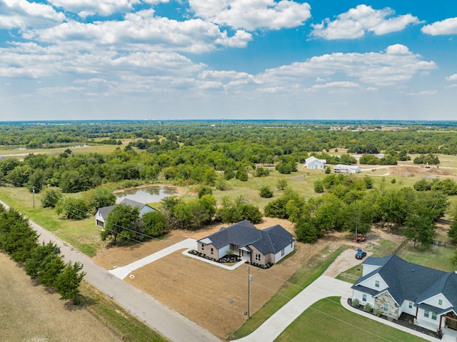 birds eye view of property with a wooded view