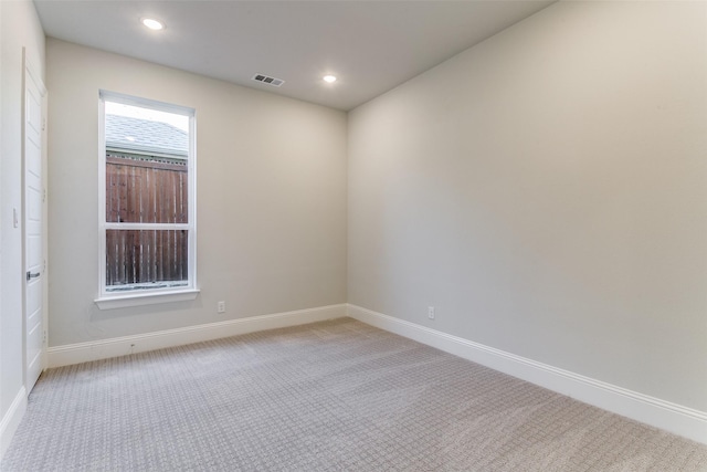 spare room featuring recessed lighting, baseboards, visible vents, and light colored carpet