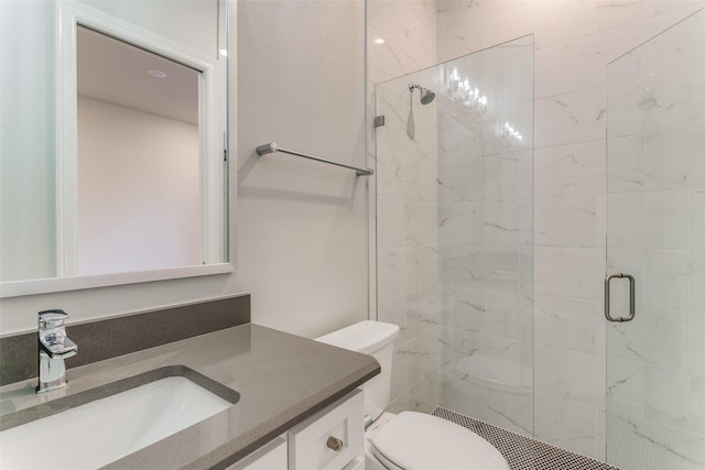 full bath featuring a stall shower, vanity, and toilet