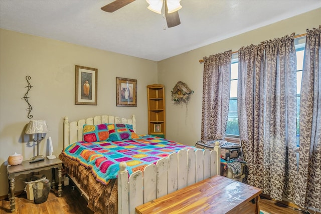 bedroom featuring a ceiling fan and wood finished floors