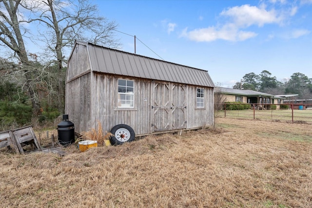 view of shed featuring fence