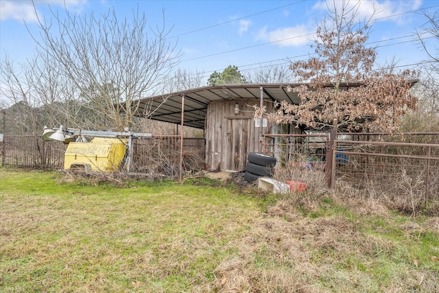 view of yard featuring fence and an outdoor structure