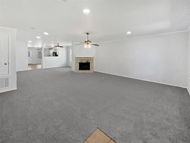 unfurnished living room with carpet floors, a fireplace, a ceiling fan, and recessed lighting