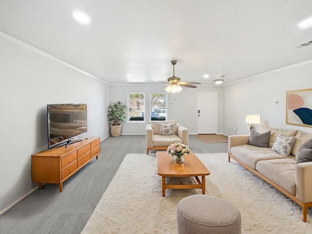 living room with crown molding, light colored carpet, visible vents, ceiling fan, and baseboards