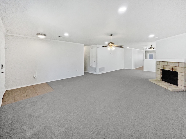 unfurnished living room featuring a stone fireplace, recessed lighting, carpet flooring, visible vents, and a ceiling fan