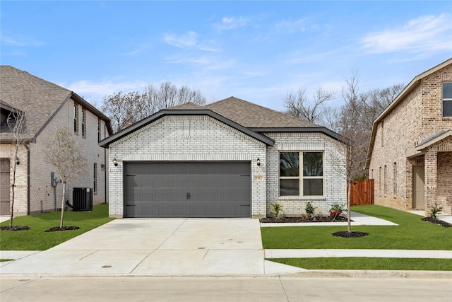 view of front of house with a front lawn, concrete driveway, brick siding, and a garage