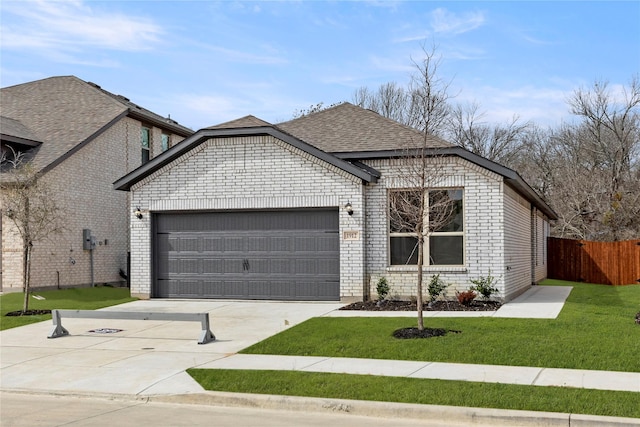 view of front facade with driveway, fence, a front yard, an attached garage, and brick siding