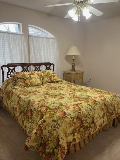 carpeted bedroom with a ceiling fan