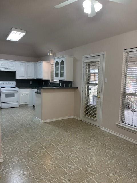 kitchen featuring electric range, white cabinets, a ceiling fan, dark countertops, and under cabinet range hood