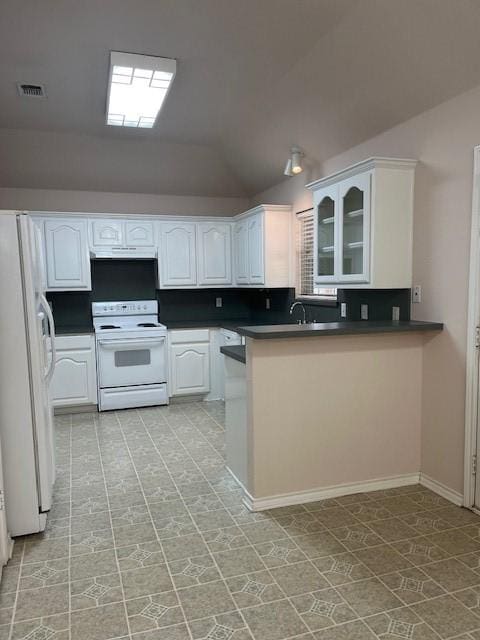 kitchen featuring dark countertops, white appliances, white cabinetry, and a peninsula