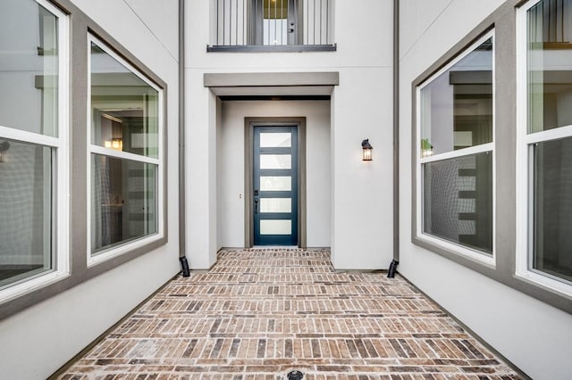 entrance to property featuring stucco siding