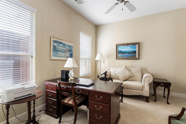 office area featuring light carpet, baseboards, and ceiling fan