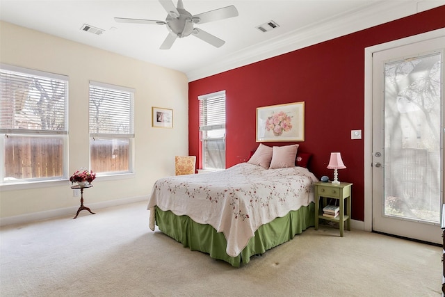 bedroom with visible vents, light colored carpet, and an accent wall