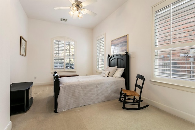 carpeted bedroom featuring baseboards, visible vents, and ceiling fan