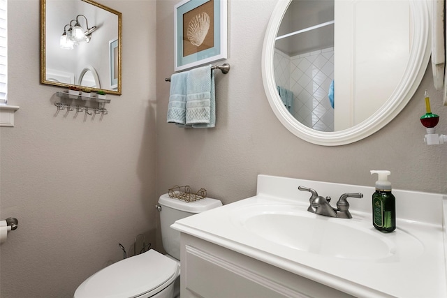 bathroom featuring curtained shower, toilet, and vanity