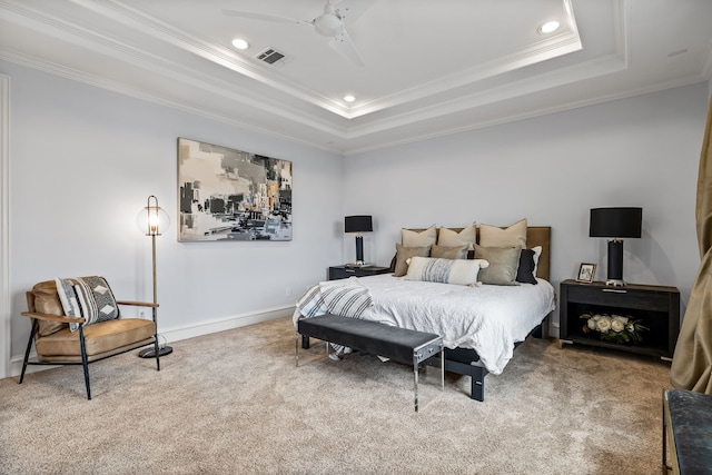 bedroom featuring carpet floors, visible vents, a raised ceiling, and ornamental molding