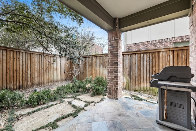 view of patio featuring a fenced backyard and area for grilling