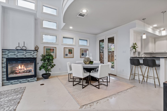 dining space with baseboards, visible vents, crown molding, a fireplace, and recessed lighting