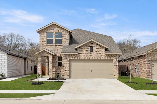 view of front of house featuring a front yard, an attached garage, brick siding, and roof with shingles