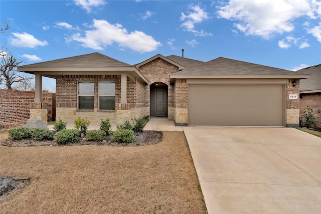 view of front of property featuring a garage, concrete driveway, brick siding, and a shingled roof