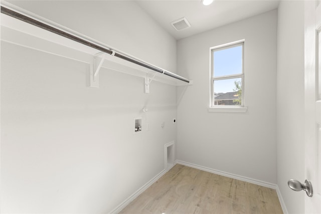 1810 Iris Rd, Melissa, TX 75454 - laundry area featuring hookup for a gas dryer, hookup for an electric dryer, light wood-type flooring, hookup for a washing machine, and baseboards