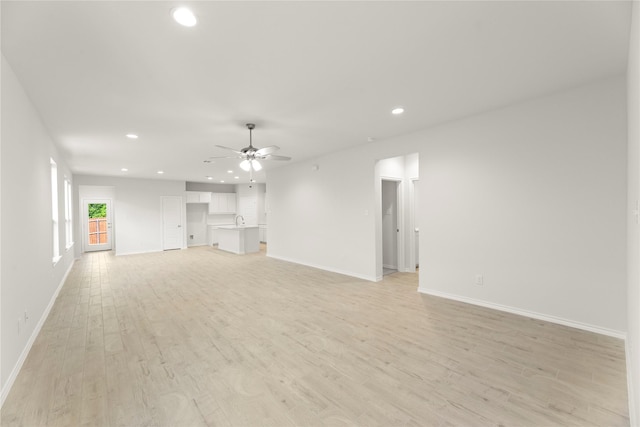 1810 Iris Rd, Melissa, TX 75454 - unfurnished living room featuring recessed lighting, baseboards, light wood-style floors, ceiling fan, and a sink