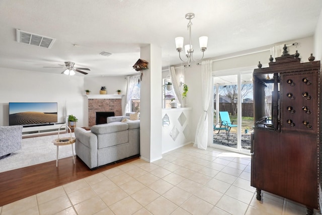 living room with visible vents, a fireplace, and light tile patterned flooring