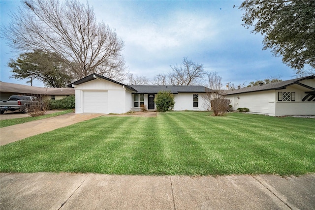 view of front of property with an attached garage, driveway, and a front yard