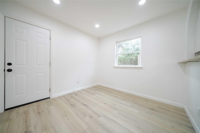 empty room featuring recessed lighting, light wood-style flooring, and baseboards