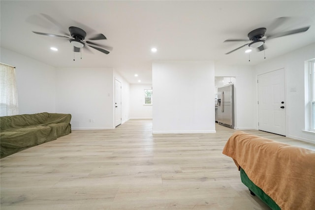 living room with light wood-type flooring, baseboards, a ceiling fan, and recessed lighting