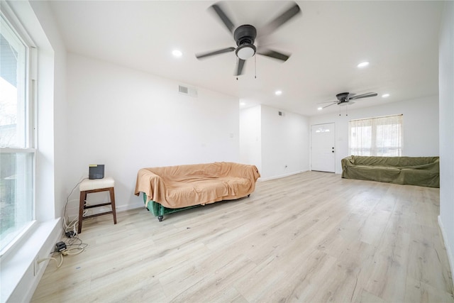 living area featuring recessed lighting, visible vents, and light wood finished floors